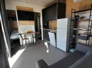 a small kitchen with a refrigerator and a table at Gabrijela House in Pirovac