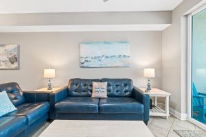 a living room with a couch and two tables at Sea Dunes 502 Beach Oasis Beachfront Condo with Pool Hot Tub Free Beach Service 0488 in Fort Walton Beach +48 photos