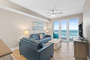 a living room with a couch and a television at Sea Dunes 502 Beach Oasis Beachfront Condo with Pool Hot Tub Free Beach Service 0488 in Fort Walton Beach