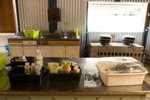 a kitchen with a sink and a counter top at Muribushi-PLUS Gramping TENT in Motobu