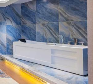 a bathroom with a white sink on a wall at 天门山云尚景豪酒店 in Zhangjiajie