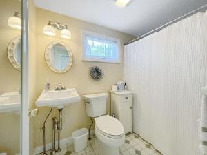 a bathroom with a toilet and a sink and a mirror at Seascapes W153 Fantastic condo steps away from Wells Beach and town center 1900 in Wells