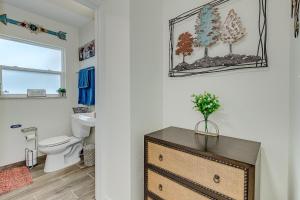 a bathroom with a toilet and a dresser at Wood Circle Art Deco Home near Disney and I4 in Lakeland +26 photos