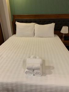 Postel nebo postele na pokoji v ubytování Gigame Signature Hotel