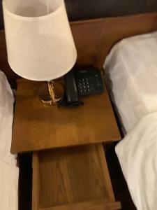 Postel nebo postele na pokoji v ubytování Gigame Signature Hotel
