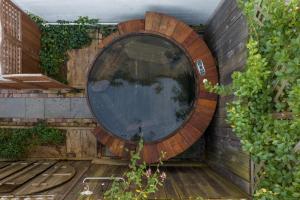 a circular window on the side of a wall at Palazzo Hudson - Luxury Pool, Hot Tub, and Sauna in Hudson