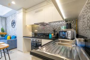 a kitchen with a sink and a microwave at Classic Canal View 2 Bhk 6pax in Dubai