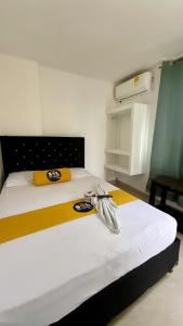Postel nebo postele na pokoji v ubytování Hotel sol de uraba
