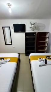 Postel nebo postele na pokoji v ubytování Hotel sol de uraba