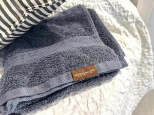 a gray towel sitting on top of a bed at Espectaculares vistas al Mediterráneo con piscina a 80 metros de la playa in San José +46 photos