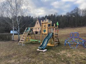 a group of playground equipment in a field at Chata Na Vyhlídce in Železnice