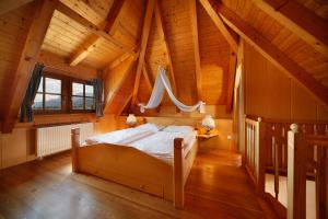 a bedroom with a bed in a wooden house at Hotel und Residence Johanneshof in Cermes +32 photos
