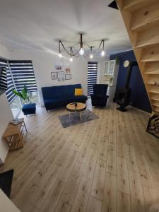 a living room with a blue couch and a table at Marina Kociewska in Ocypel