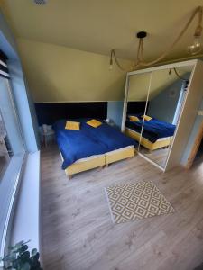 a bedroom with a bed and a large mirror at Marina Kociewska in Ocypel