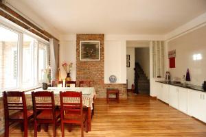 a kitchen and dining room with a table and chairs at Loankim Homestay in Hue