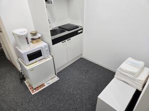 Kuchyň nebo kuchyňský kout v ubytování 旅館やすらぎ