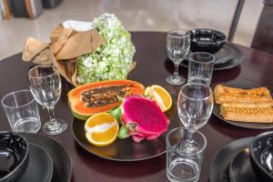 a table with plates of food and wine glasses at Sunbeji - Relax and Unwind - Seminyak Luxury Stay with Private Pool in Seminyak