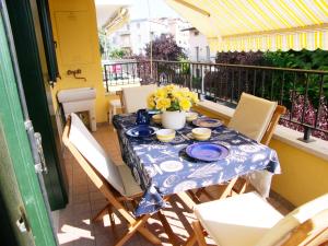 a table with a blue and white table cloth on a balcony at Casa Sonneninsel in Grado