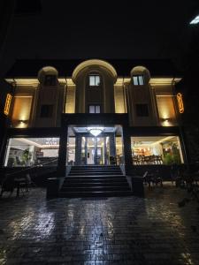 a building at night with stairs in front of it at Vatan Plaza in Tashkent
