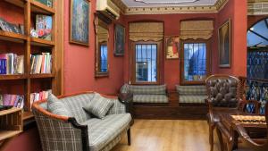 a living room with a couch and some windows at Istanbul Irish Hotel in Istanbul