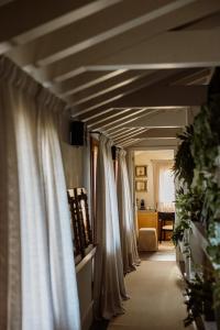 a row of white curtains in a room at Casa TOMA - Luxury Garden House in Arzignano