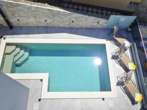 an overhead view of a swimming pool with chairs at Holiday Home Maslenica with Pool near Beach in Maslenica