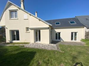 a large white house with a green yard at Le Moulin in Saint-Pair-sur-Mer