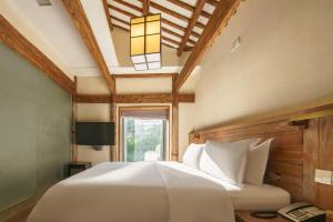 Voodi või voodid majutusasutuse Huangshan Shanshui Boutique Hotel Liyang Scenic Area toas