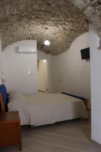 a bedroom with a bed and a stone ceiling at Il Viandante Bed & Breakfast in Roseto Valfortore