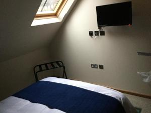 a bedroom with a bed and a flat screen tv at York Aparthotel in York