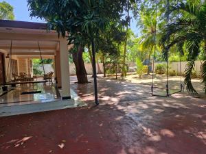 a swing in the courtyard of a house at Leela Resort in Karainagar