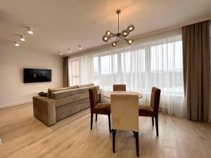 a living room with a table and a couch at Panoramic Lake View in Chişinău +14 photos