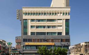 a tall building in the middle of a city at Kindness Hotel - Yuanlin Branch in Yuanlin