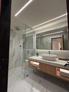 a bathroom with a sink and a shower at Taj Inn Hotel in Agra +41 photos