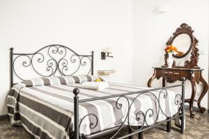 a bedroom with a black and white bed and a mirror at Palazzo Angelelli in Gallipoli