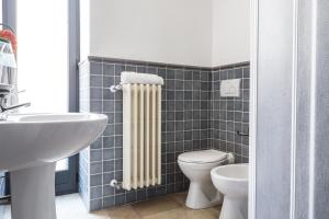 a bathroom with a white toilet and a radiator at Palazzo Angelelli in Gallipoli +91 photos