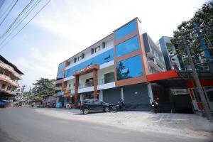 a building with a car parked in front of it at TTS Residency in Kaliyal