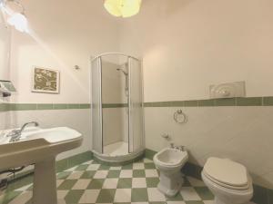 a bathroom with a shower and a toilet and a sink at Downtown Grandama Home della Cassatella - Air Conditioner&wifi in Castellammare del Golfo +6 photos
