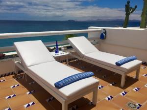 a balcony with two chairs and a table on a yacht at CABALLITO DE MAR (SEAHORSE) in Playa Blanca