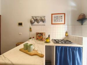 a kitchen with a stove and a counter top at Downtown Grandama Home della Cassatella - Air Conditioner&wifi in Castellammare del Golfo