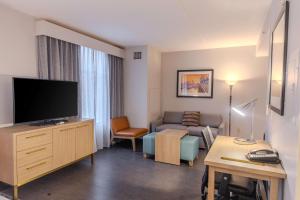 a living room with a couch and a flat screen tv at Homewood Suites - Doylestown in Warrington