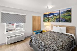 a hotel room with a bed and a window at Birch Hill Suites Rochester - Med City in Rochester