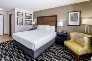 a hotel room with a bed and a chair at La Quinta Inn by Wyndham Steamboat Springs in Steamboat Springs