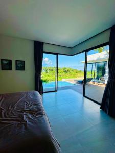 a bedroom with a bed and a view of a pool at Balisen Luxury Villas in Jasri