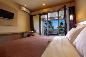 Ένα ή περισσότερα κρεβάτια σε δωμάτιο στο Sunset House Gili Meno