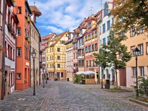 an empty street in a city with buildings at Living Hotel Nürnberg in Nuremberg