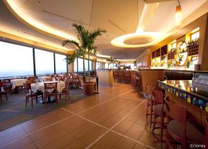 a restaurant with tables and chairs and a bar at Disney's Contemporary Resort in Orlando