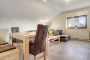 a living room with a table and a couch at Mill Nordkirchen in Nordkirchen +16 photos