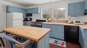 WaitsfieldにあるStrong House homeの青いキャビネットと木製のカウンタートップを備えたキッチン +44枚の写真