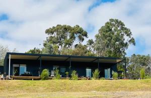 a modern house with a black facade at Circle of Light Retreat in Kangaroo Gully